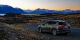 Image of a Toyota Rav4 at dusk overlooking a lake and mountains of the South Island