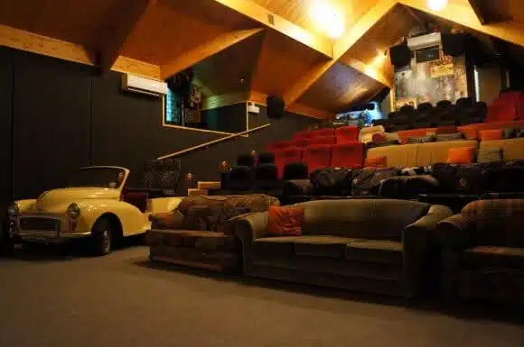 Image showing the inside of Cinema Paradiso in Wanaka New Zealand with old sofas and a seat made out of an old car