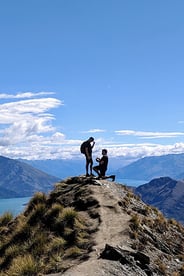 Aerial image of a road in the South Island with a lake and mountain in the background
