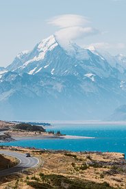 Image of Lake Pukaki in the South Island with the road in the foreground and mountains in the background