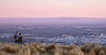 Image of Christchurch city taken from the Port Hills at dusk with the Southern Alps in the background