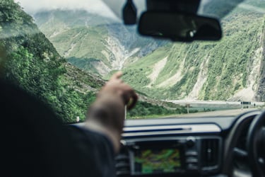 Image from the interior of a GO Rentals hire car heading down the winding slopes of a South Island mountain