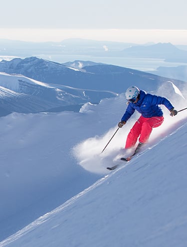 A person skiing down a slope at Ruapehu New Zealand