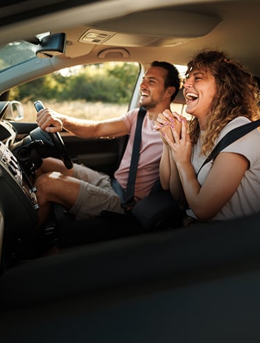 A couple enjoying a road trip through New Zealand with GO Rentals