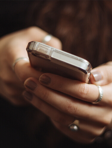 Woman's hands typing on a mobile phone