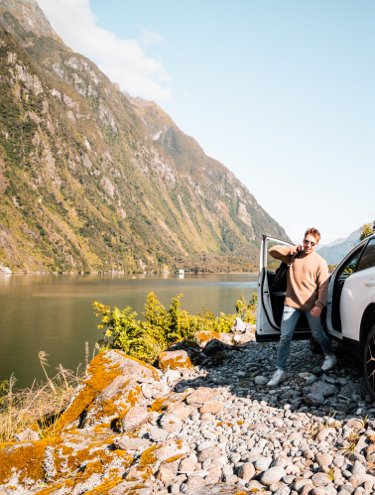 Image of a Toyota Rav4 at dusk overlooking the lakes and mountains of the South Island