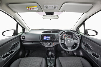 Interior image of an MG3 rental car taken from back seat looking at modern dashboard and entertainment system