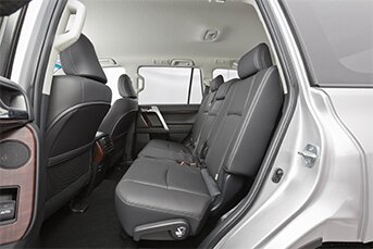 Interior rear image of a Toyota Land Cruiser Prado 4x4 rental car showing back seats