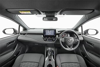 Interior front image of a Toyota Corolla rental car showing the dashboard and entertainment system
