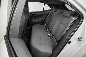 Interior rear image of a Toyota Corolla rental car showing the back seats
