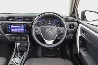 Interior front image of a Toyota Corolla touring sedan showing the dashboard and entertainment system