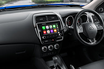 Interior front image of a Toyota CHR rental car showing the dashboard and entertainment system