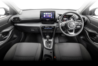 Interior front  image of a Toyota Camry Hybrid rental car showing the dashboard and entertainment system