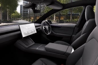 Front interior of a Tesla Model Y Long Range with touchscreen dashboard