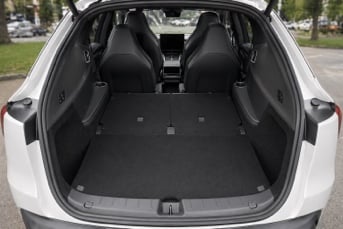 Tesla Model Y L trunk with seats folded flat showing large cargo space