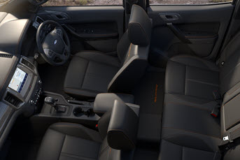 Interior image of the front of a Toyota Hilux 4x4 showing the dashboard and entertainment system