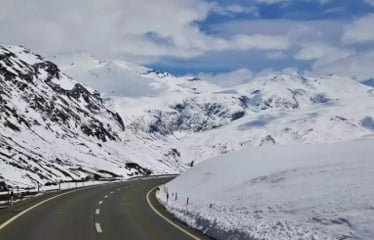 Scenic mountain road winding through a snow-covered landscape