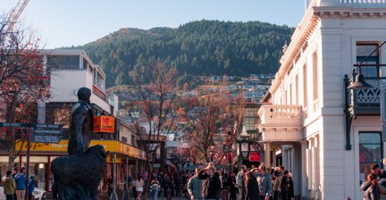 Bustling city center with shops and mountain views