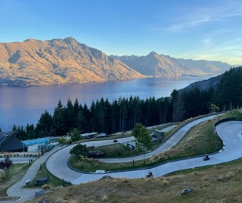 Winding luge track overlooking a lake and mountains