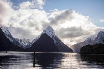 Scenic view of Milford Sound with snow-capped peaks and water reflections