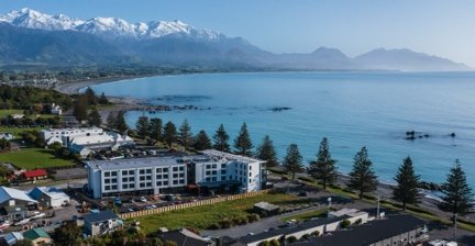Sudima Kaikōura hotel by the coastline with mountains in the background