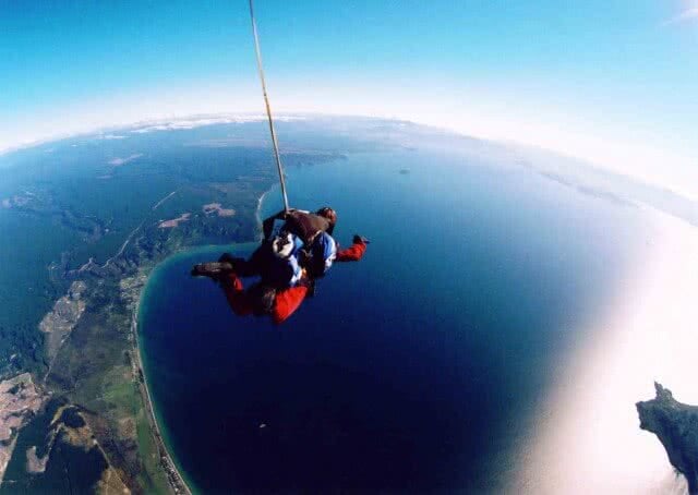 Image of a tandem skydiver over the shores of Lake Taupo