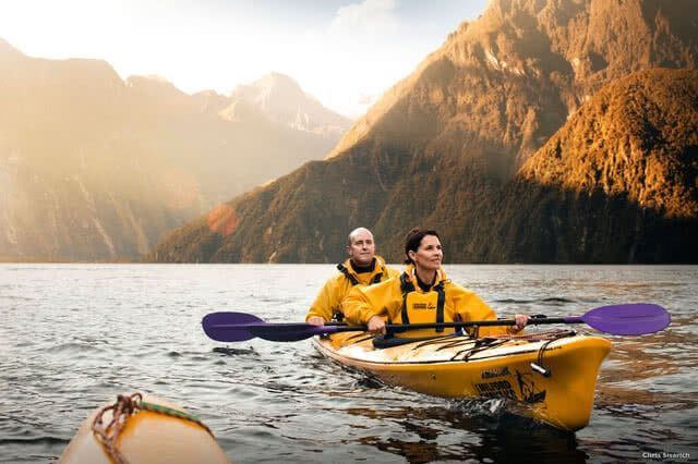 Image of two people kayaking on Milford Sound with Mitre Peak in the backdrop