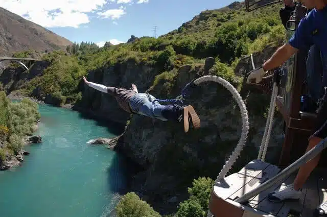 Image of someone taking a dive of the platform of a bungy jump in Queenstown New Zealand