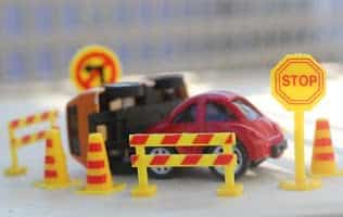 Image of a road safety crash depicted by toys cars