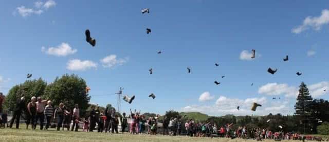 Image of people throwing gumboots to celebrate the annual Gumboot Day in Taihape. In 2015, the event celebrates its 30th year