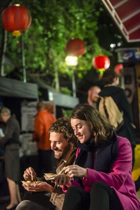 Image of people eating street food at the Wellington on a Plate Night Market