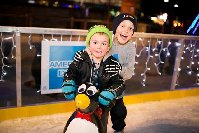 Image of two young kids on the ice rink at the Audi Quattro Winter Games in Queenstown