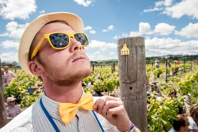 Image of a smartly dressed chap at Toast Martinborough wearing a yellow bow tie and sunglasses