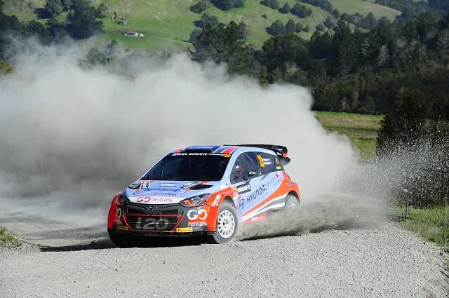 Image of the Hyundai Rally car driven by Hayden Paddon skidding round a corner