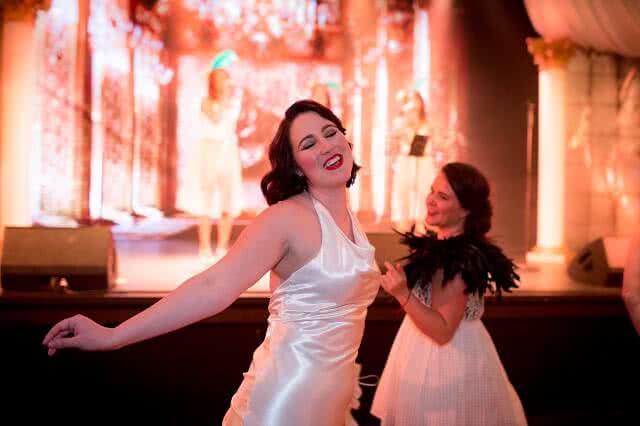 Image of Two ladies dressed up in white ball gowns for the American Express Queenstown Winter Festival Ball