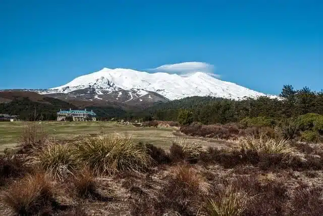 Active volcano Mount Ruapehu with Whakapapa Village and Chateau Tongariro in Tongariro National Park, North Island, New Zealand - popular ski resort and tourist travel destination