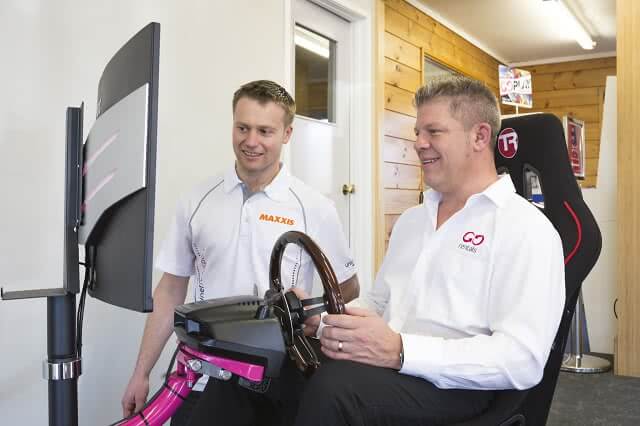 Two men using GO Rentals Driving simulator