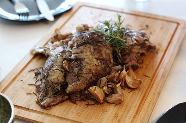 A large portion of Roast lamb on a board