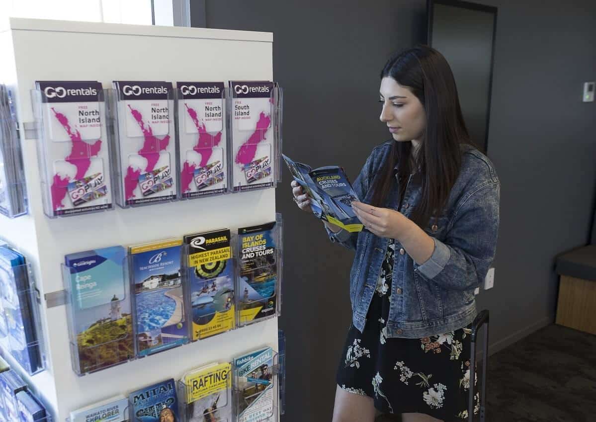 A young female looking at maps in the GO Rentals branch