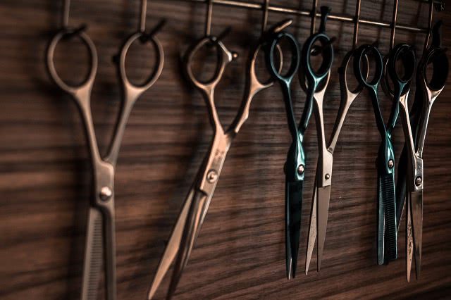 Image of scissors hung up at a hairdressers salon