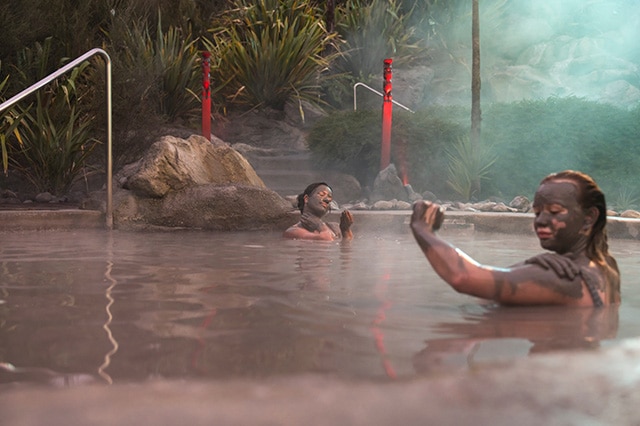 two women relaxing in the geothermal mud pool