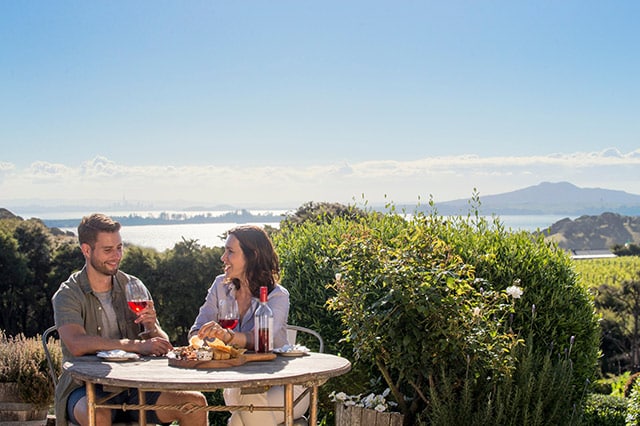 A couple drinking wine on Waiheke Island