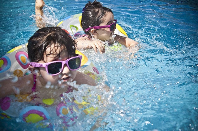 two children swimming in pool