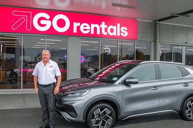 John Osborne standing in front of BYD Atto 3 vehicle in front of GO Rentals branch