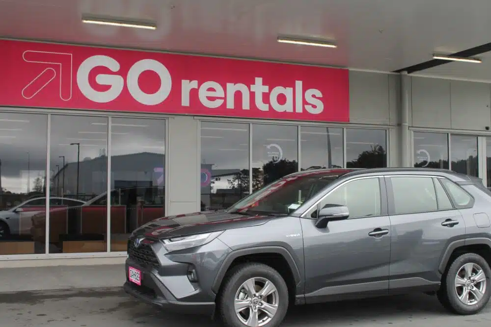 dark grey Toyota RAV4 Hybrid car in front of go rentals branch