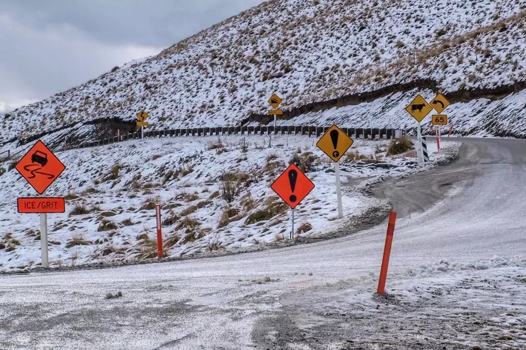 Slippery road warning snow mountain